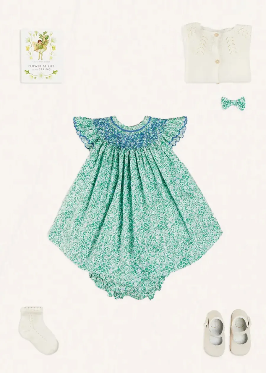 Pepa London Adelaide Floral Hand Smocked Sleeveless Dress With Bloomers in Green (3mths-3yrs) | Openwork Cotton Cardigan in Cream (6mths-10yrs) | Leather Mary Jane Pram Shoes in Ivory (17-20EU) | Adelaide Floral Small Bow Hair Clip in Green | Openwork short socks White (0mths-8yrs) | Flower Fairies of the Spring Book in White