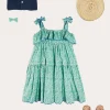 Pepa London Adelaide Floral Tiered Tie Strap Dress in Green (4-12yrs) | Plain Cardigan in Navy (6mths-10yrs) | Metallic Strappy Leather Sandals in Gold (24-35EU) | Adelaide Floral Detail Raffia Bag in Green | Adelaide Floral Small Bow Hair Clip in Green