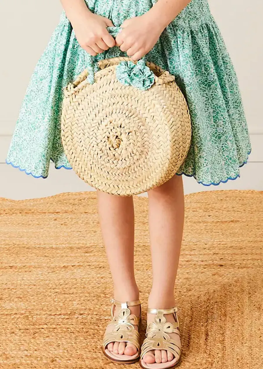 Pepa London Adelaide Floral Tiered Tie Strap Dress in Green (4-12yrs) | Plain Cardigan in Navy (6mths-10yrs) | Metallic Strappy Leather Sandals in Gold (24-35EU) | Adelaide Floral Detail Raffia Bag in Green | Adelaide Floral Small Bow Hair Clip in Green