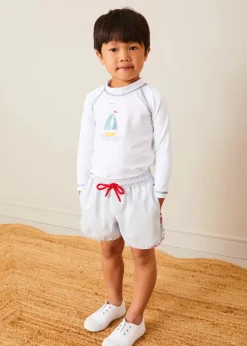 BOY Pepa London Boat Motif Long Sleeve Rashguard in Blue (2-6yrs) | Striped Contrast Trim Swim Shorts in Blue (2-10yrs) | Canvas Plimsolls in White (20-34EU) | Little Brother Beach Mouse Toy