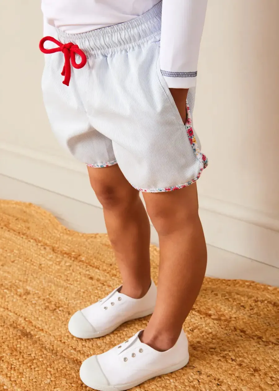 BOY Pepa London Boat Motif Long Sleeve Rashguard in Blue (2-6yrs) | Striped Contrast Trim Swim Shorts in Blue (2-10yrs) | Canvas Plimsolls in White (20-34EU) | Little Brother Beach Mouse Toy