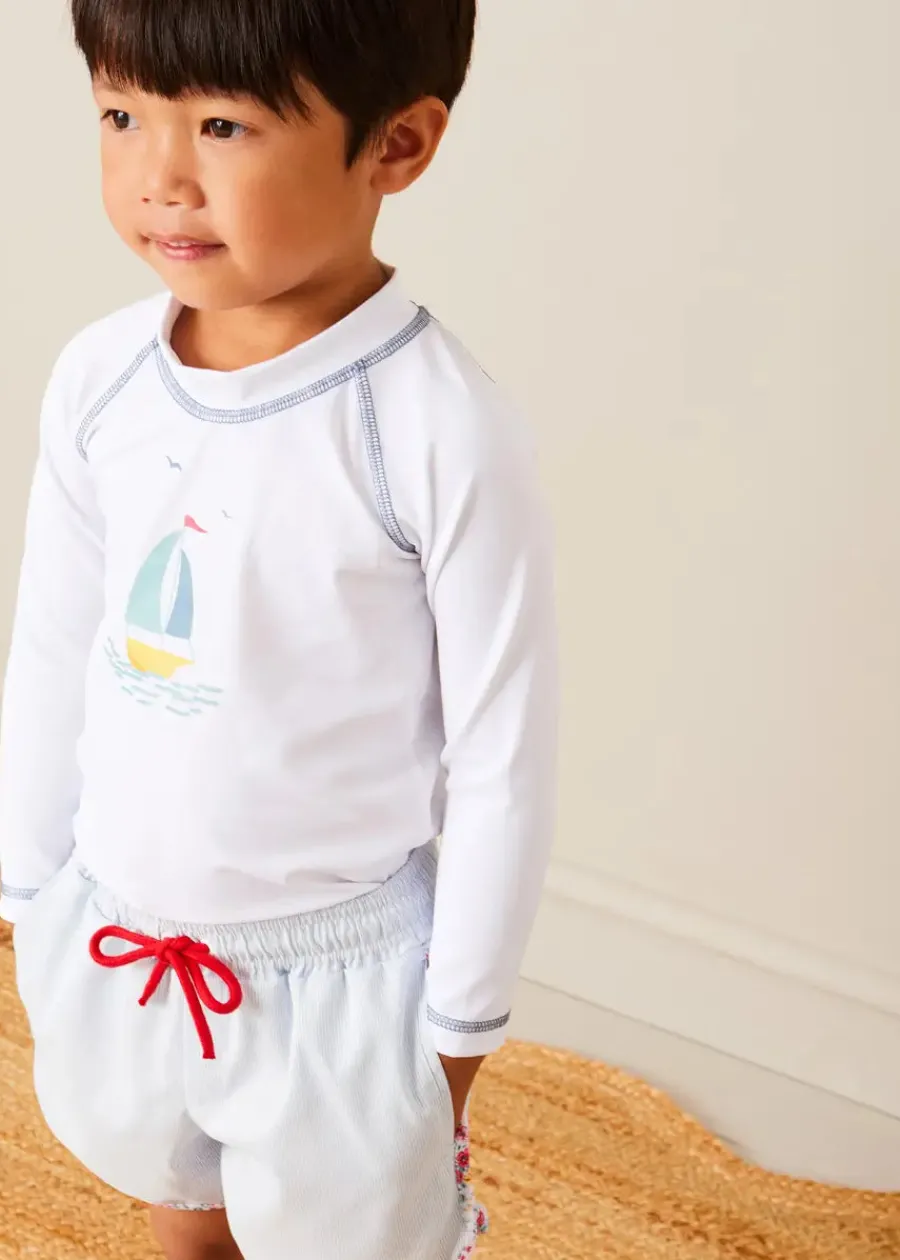 BOY Pepa London Boat Motif Long Sleeve Rashguard in Blue (2-6yrs) | Striped Contrast Trim Swim Shorts in Blue (2-10yrs) | Canvas Plimsolls in White (20-34EU) | Little Brother Beach Mouse Toy