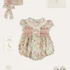 Pepa London Clementine Floral Hand Smocked Double Breasted Short Sleeve Romper in Coral (6mths-3yrs) | Clementine Floral Hand Smocked Bonnet in Coral (S-M) | Openwork Cotton Cardigan in Cream (6mths-10yrs) | Leather Mary Jane Pram Shoes in Ivory (17-20EU) | Openwork short socks White (0mths-8yrs)