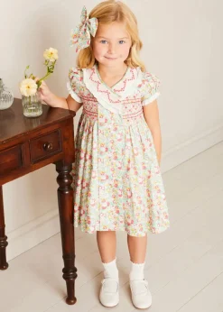 Pepa London Clementine Floral Hand Smocked Double Breasted Short Sleeve Dress in Coral (12mths-10yrs) | Mary Jane Leather Baby Shoes in Ivory (20-24EU) | Clementine Floral Long Bow Hair Clip in Coral | Openwork short socks White (0mths-8yrs)