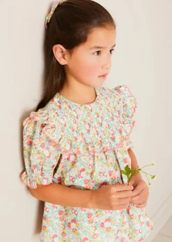 Pepa London Clementine Floral Smock Detail Short Sleeve Blouse in Coral (2-12yrs) | Scallop Trim Embroidered Shorts in White (2-10yrs) | Clementine Floral Quilted Reversible Jacket in Coral (4-12yrs) | Floral Openwork Cotton Cardigan in Pink (2-10yrs) | Linen Ballerina Shoes in Ivory (24-36EU) | Clementine Floral Long Bow Hair Clip in Coral | Little People, Big Dreams - Frida Kahlo Book in Green