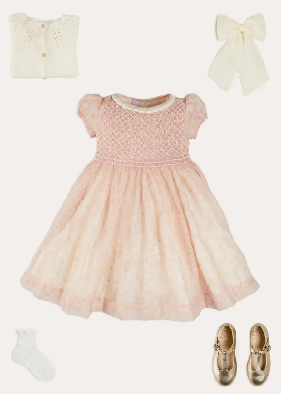 Pepa London Constance Floral Hand Smocked Short Sleeve Party Dress in Pink (12mths-10yrs) | Openwork Cotton Cardigan in Cream (6mths-10yrs) | Leather Charlotte Shoes in Gold (24-35EU) | Tulle Long Bow Clip In Cream | Celebration Short Socks with Ruffle- Cream (0mths-10yrs)