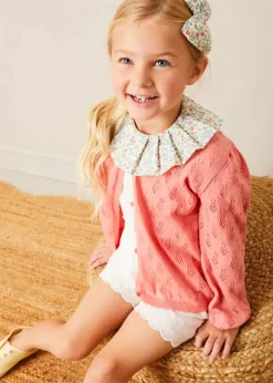 Pepa London Cordelia Floral Collar Top in Pink Made with Liberty Fabric (2-10yrs) | Scallop Trim Embroidered Shorts in White (2-10yrs) | Floral Openwork Cotton Cardigan in Pink (2-10yrs) | Canvas Plimsolls in Cream (20-35EU) | Cordelia Floral Medium Bow Clip in Pink Made with Liberty Fabric | The Tale Of Kitty In Boots Book in White