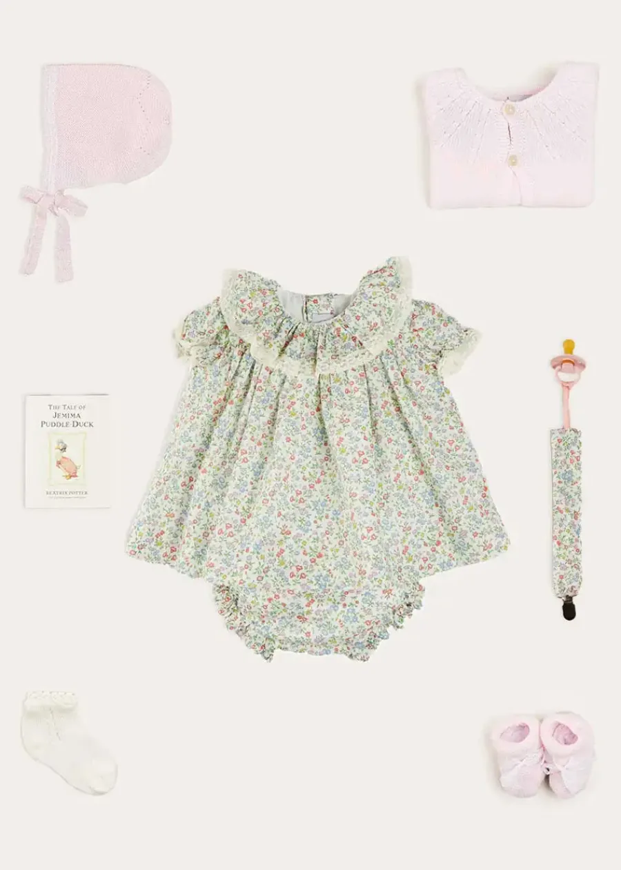 Pepa London Cordelia Floral Ruffle Collar Short Sleeve Dress in Green Made with Liberty Fabric (1-12m) | Openwork Detail Baby Cardigan in Pink (1-12mths) | Lace Detail Knitted Bonnet in Pink (1-12mths) | Lace Detail Knitted Booties in Pink | Cordelia Liberty Floral Dummy Clip in Pink | Openwork short socks White (0mths-8yrs) | BIBS Dummy in Pink