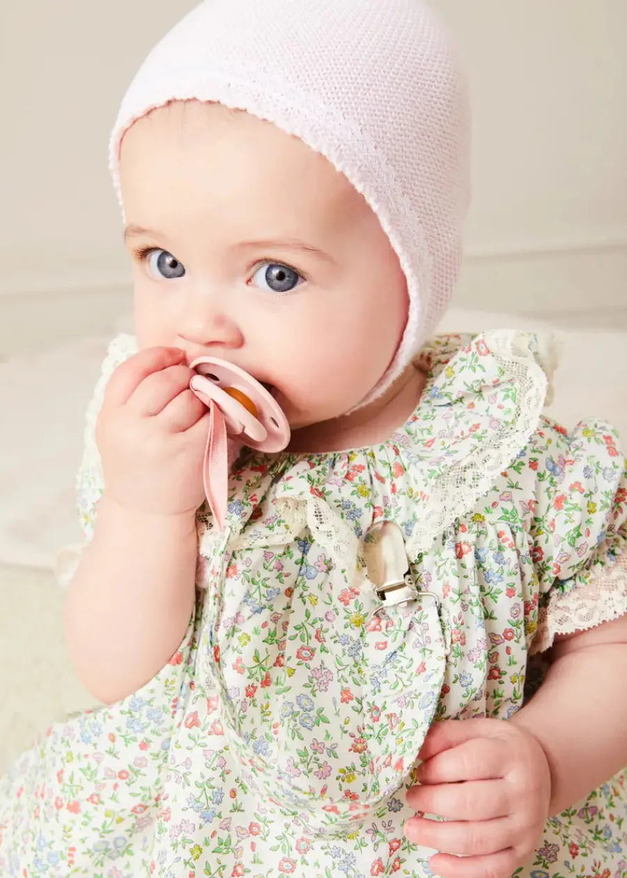 Pepa London Cordelia Floral Ruffle Collar Short Sleeve Dress in Green Made with Liberty Fabric (1-12m) | Openwork Detail Baby Cardigan in Pink (1-12mths) | Lace Detail Knitted Bonnet in Pink (1-12mths) | Lace Detail Knitted Booties in Pink | Cordelia Liberty Floral Dummy Clip in Pink | Openwork short socks White (0mths-8yrs) | BIBS Dummy in Pink