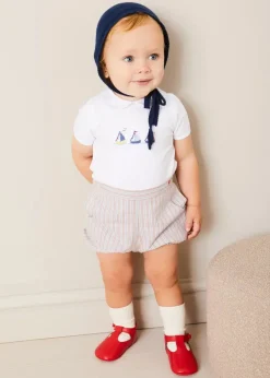 BOY Pepa London Embroidered Boat Motif Peter Pan Collar Bodysuit in White (1mth-3yrs) | Beaufort Striped Button Detail Bloomers in Red (3mths-3yrs) | Plain Cardigan in Navy (6mths-10yrs) | Openwork Knitted Bonnet in Navy (S-L) | T-Bar Pram Shoes in Red (17-20EU) | Ribbed Short Socks - Cream (0mths-10yrs)
