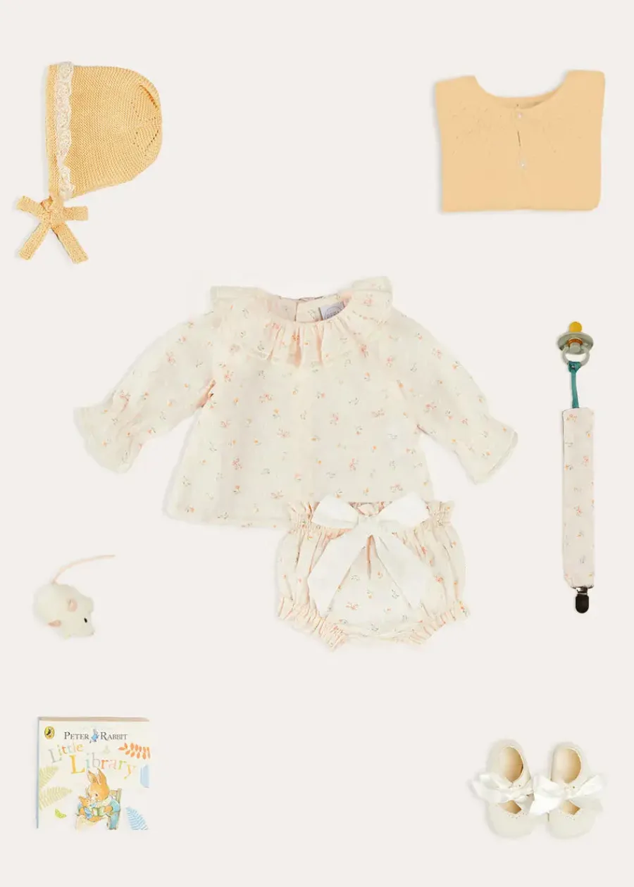 Pepa London Esme Floral Ruffle Collar Long Sleeve Blouse in White (1-12mths) | Esme Floral Bow Detail Bloomers in White (1-12mths) | Openwork Detail Cotton Baby Cardigan in Tangerine (1-12mths) | Lace Detail Knitted Bonnet in Tangerine (1-12mths) | Celebration Ribbon Detail Mary Jane Pram Shoes in Beige (17-20EU) | Esme Floral Dummy Clip in White | Little Library Book in White | White Mouse Toy