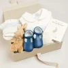 Pepa London Gift boxes | Off White and Blue Hand Smocked Baby Bonnet | Plain high socks - Cream (0mths-10yrs) | Leather T-Bar Pram Shoes in Classic Blue (17-20EU) | My First Bunny in a Box - Blue