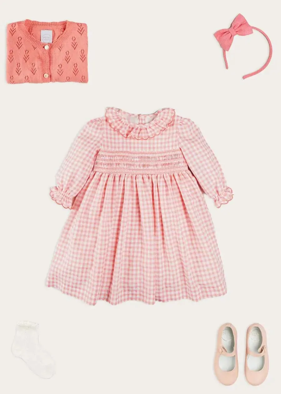 Pepa London Gingham Smocked Ruffle Collar Long Sleeve Dress in Coral (12mths-10yrs) | Floral Openwork Cotton Cardigan in Pink (2-10yrs) | Girls Ivory Leather Mary Jane Shoes (20-34EU) | Raspberry Linen Hairband | Openwork short socks White (0mths-8yrs)
