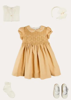 Pepa London Hand Smocked Peter Pan Collar Short Sleeve Dress in Beige (12mths-10yrs) | Openwork Cotton Cardigan in Cream (6mths-10yrs) | Mary Jane Leather Baby Shoes in Ivory (20-24EU) | Traditional Big Bow Tulle Hairband in Ivory | Celebration Short Socks with Ruffle- Cream (0mths-10yrs)