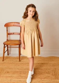 Pepa London Hand Smocked Peter Pan Collar Short Sleeve Dress in Beige (12mths-10yrs) | Openwork Cotton Cardigan in Cream (6mths-10yrs) | Girls Ivory Leather Mary Jane Shoes (20-34EU) | Traditional Big Bow Tulle Hairband in Ivory | Celebration Short Socks with Ruffle- Cream (0mths-10yrs) | Tulle Long Bow Clip In Cream