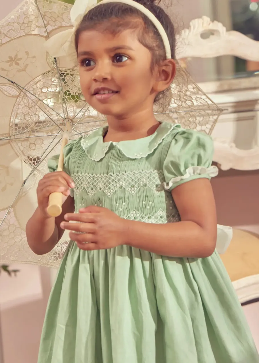 Pepa London Hand Smocked Peter Pan Collar Short Sleeve Dress in Green (12mths-10yrs) | Openwork Cotton Cardigan in Cream (6mths-10yrs) | Girls Ivory Leather Mary Jane Shoes (20-34EU) | Traditional Big Bow Tulle Hairband in Ivory | Flower Fairies of the Spring Book in White | Openwork short socks White (0mths-8yrs)