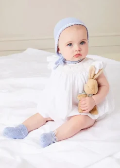 Pepa London Hand Smocked Sleeveless Romper in White (3-18mths) | Openwork Detail Baby Cardigan in Blue (1-12mths) | Lace Detail Knitted Bonnet in Blue (1-6mths) | Ellis Rounded Bib with Embroidery in Blue Made with Liberty Fabric | Lace Detail Knitted Booties in Blue | Ellis Dummy Clip in Blue Made with Liberty Fabric | My First Bunny in a Box - Blue | BIBS Dummy in Blue