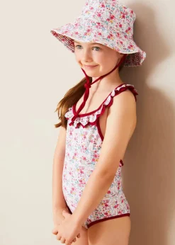 Pepa London Louisa Floral Ruffle Trim Swimsuit in Pink (2-10yrs) | Louisa Floral Beach Hat in Pink (S-M) | Louisa Floral Detail Raffia Bag in Coral | Leather Buckle Detail Sandals in Camel (24-34EU)