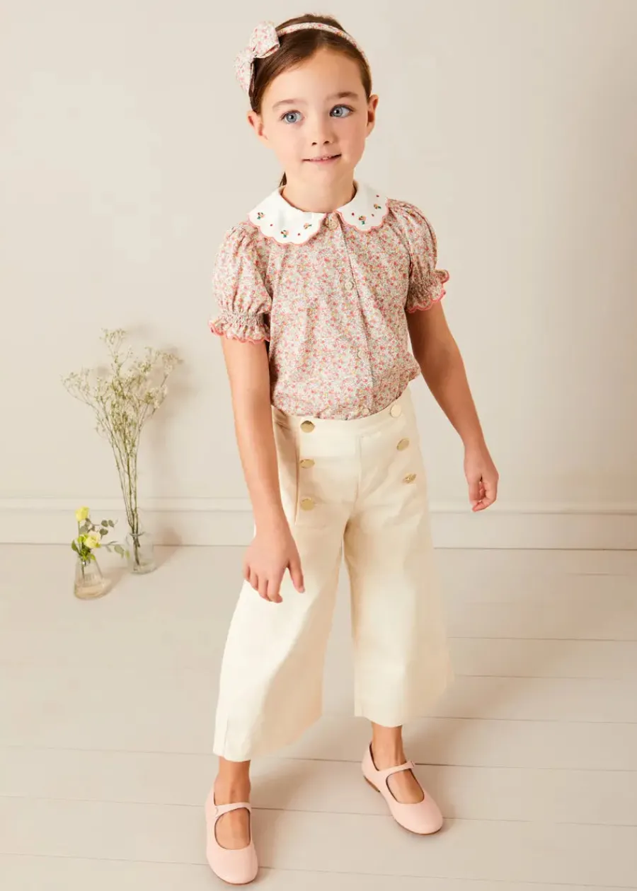 Pepa London Mabel Floral Embroidered Short Sleeve Blouse in Coral (18mths-10yrs) | Wide Leg Front Button Trousers in Beige (2-10yrs) | Floral Openwork Cotton Cardigan in Pink (2-10yrs) | Openwork short socks - Dusty Pink (0mths-10yrs) | Leather Mary Jane Shoes in Pink (24-34EU) | Mabel Floral Hairband in Coral