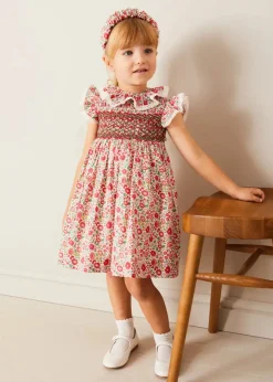 Pepa London Margot Hand-Smocked Dress in Red Made with Liberty Fabric (12m-6yrs) | Openwork Cotton Cardigan in Cream (6mths-10yrs) | Mary Jane Leather Baby Shoes in Ivory (20-24EU) | Margot Liberty Floral Scrunchie Hairband in Red | Openwork short socks White (0mths-8yrs)
