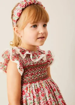 Pepa London Margot Hand-Smocked Dress in Red Made with Liberty Fabric (12m-6yrs) | Openwork Cotton Cardigan in Cream (6mths-10yrs) | Mary Jane Leather Baby Shoes in Ivory (20-24EU) | Margot Liberty Floral Scrunchie Hairband in Red | Openwork short socks White (0mths-8yrs)