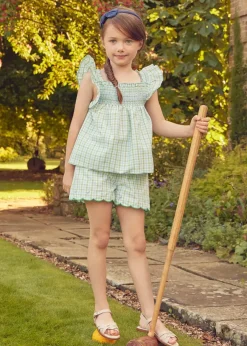 Pepa London Maxwell Gingham Smock Detail Blouse in Green (5-10yrs) | Maxwell Gingham Scallop Trim Embroidered Shorts in Green (18mths-10yrs) | Floral Openwork Cotton Cardigan in Green (2-10yrs) | Leather Woven Detail Sandals in Beige (24-35EU) | Navy Linen Big Bow Hairband | Flower Fairies of the Spring Book in White