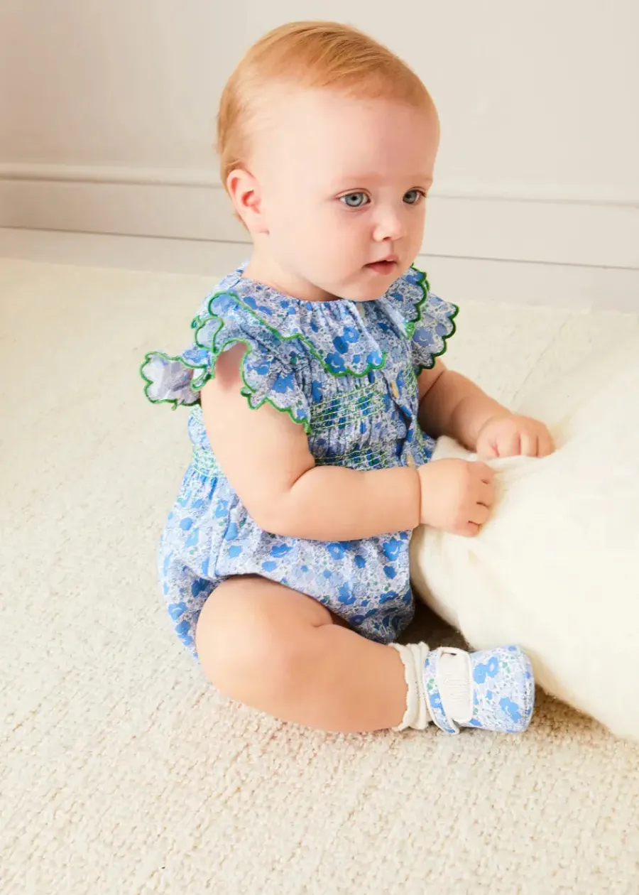 Pepa London Olivia Floral Smocked Ruffle Collar Sleeveless Romper in Blue (6mths-2yrs) | Plain Cardigan in Navy (6mths-10yrs) | Openwork Knitted Bonnet in Navy (S-L) | Olivia Floral Mary Jane Pram Shoes in Blue (17-20EU) | Openwork short socks White (0mths-8yrs) | Flower Fairies of the Summer Book in White