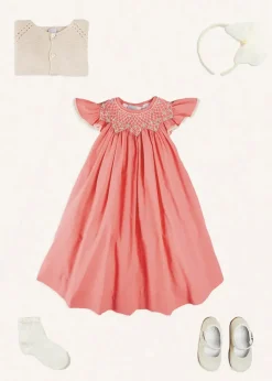 Pepa London Plain Hand Smocked Sleeveless Dress in Coral (12mths-10yrs) | Plain Cardigan in Cream (6mths-10yrs) | Girls Ivory Leather Mary Jane Shoes (20-34EU) | Traditional Big Bow Tulle Hairband in Ivory | Openwork short socks White (0mths-8yrs)