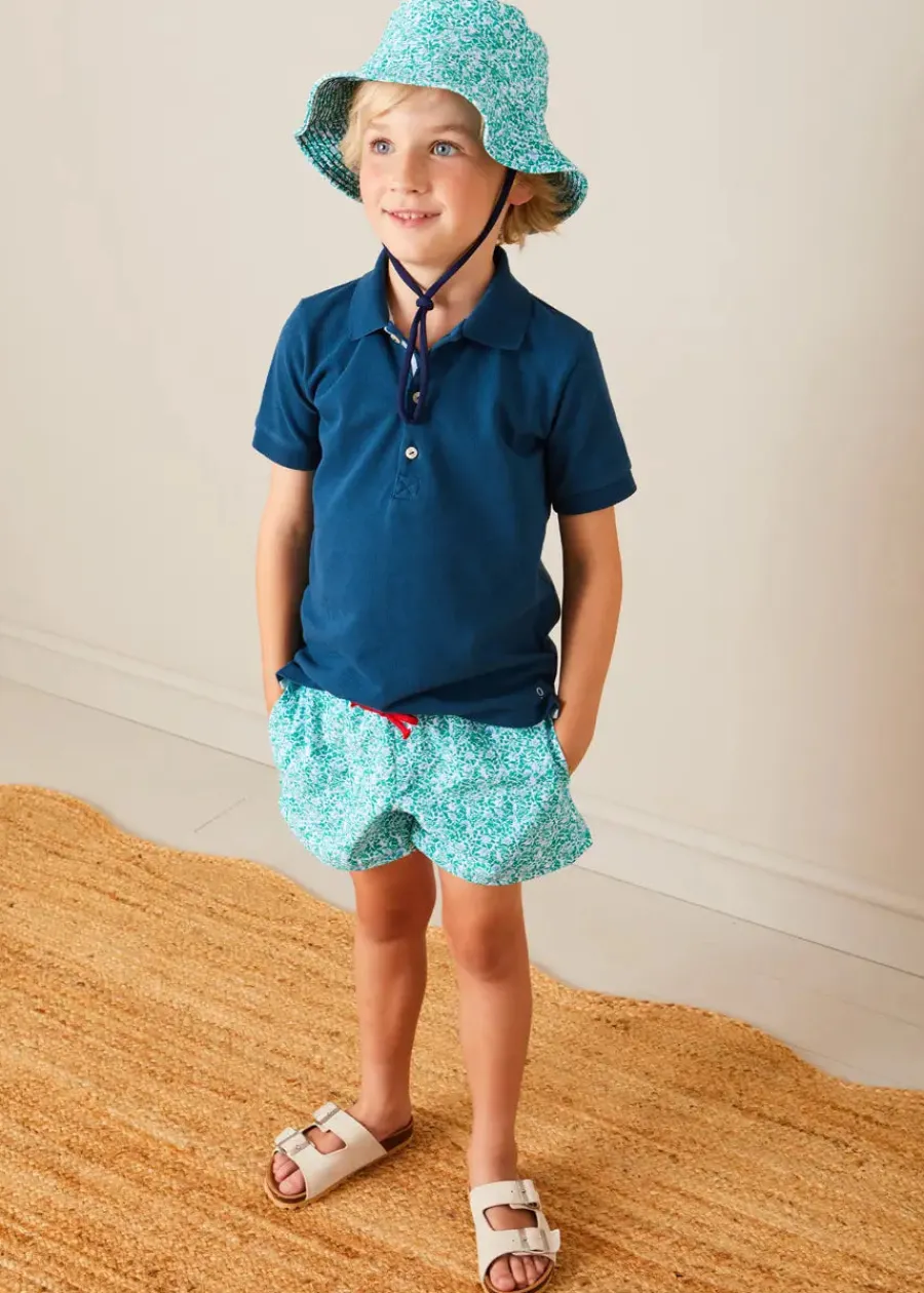 BOY Pepa London Plain Short Sleeve Polo Shirt in Navy (2-10yrs) | Adelaide Floral Tie Detail Swim Shorts in Green (2-10yrs) | Suede Buckle Detail Sandals in Beige (28-35EU) | Adelaide Floral Beach Hat in Green (S-M) | Big Brother Beach Mouse Toy