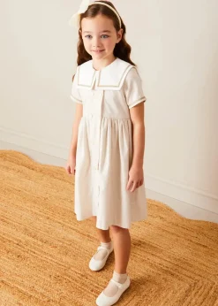 Pepa London Waterford Striped Mariner Collar Double Breasted Short Sleeve Dress in Beige (12mths-10yrs) | Openwork Cotton Cardigan in Cream (6mths-10yrs) | Girl's Beige Leather Celebration Shoes (20-34EU) | Tulle Long Bow Clip In Cream | Cotton Short Socks Cream (0mths-10yrs)